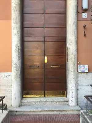 a wooden door on the side of a building at in the garden in Rome