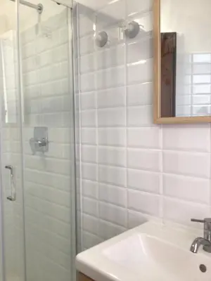 a bathroom with a shower and a sink and a mirror at in the garden in Rome