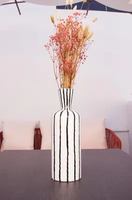 a vase with flowers in it sitting on a table at Navona Penthouse - Attico Vista Cupola 4 posti in Rome