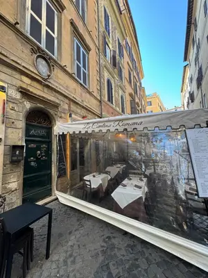 a restaurant with tables inside of a building at Navona Penthouse - Attico Vista Cupola 4 posti in Rome