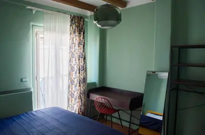 a bedroom with a bed and a desk and a window at Navona Penthouse - Attico Vista Cupola 4 posti in Rome