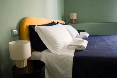 a hotel room with a bed with pillows and towels at Navona Penthouse - Attico Vista Cupola 4 posti in Rome