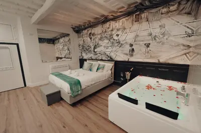 a bedroom with a bed and a painting on the wall at Mirror Suite Roma Colosseo Monti con Jacuzzi in Rome