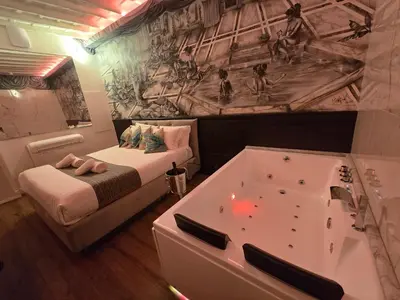 a bedroom with a bed and a bath tub at Mirror Suite Roma Colosseo Monti con Jacuzzi in Rome