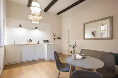a living room with a table and a kitchen at Cinque Loft in Rome