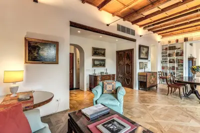 a living room with a table and chairs at Trastevere Outstanding 4 BR Terraced Apartment in Rome