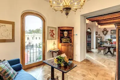 a living room with a blue couch and a table at Trastevere Outstanding 4 BR Terraced Apartment in Rome