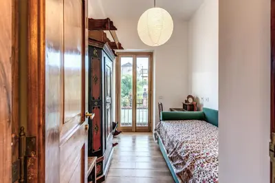 a room with a green couch and a door at Trastevere Outstanding 4 BR Terraced Apartment in Rome