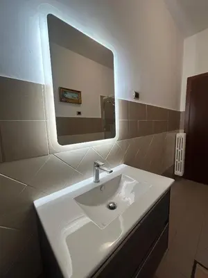a bathroom with a white sink and a mirror at Casa dei fiori by GHOR in Rome