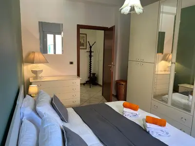 a bedroom with a large bed and a mirror at Casa dei fiori by GHOR in Rome