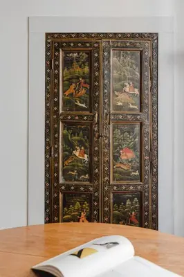 a wooden door with paintings on a wall with a computer mouse at Giusi Trevi Apartment in Rome