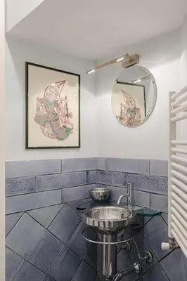 a bathroom with a sink and a mirror at Giusi Trevi Apartment in Rome