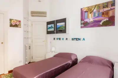 a room with two beds and a painting on the wall at Giusi Trevi Apartment in Rome
