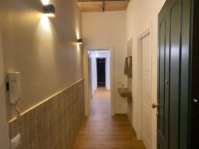 a hallway leading to a bathroom with a sink at Eutierra BLeisure Stay in Rome