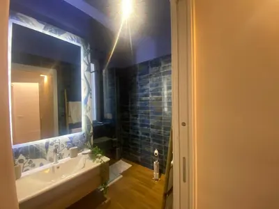 a bathroom with a sink and a mirror at Eutierra BLeisure Stay in Rome