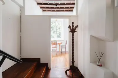 a hallway with a staircase and a table in a room at Dadi Inn Monti in Rome
