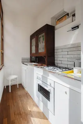 a kitchen with white cabinets and a stove at Dadi Inn Monti in Rome