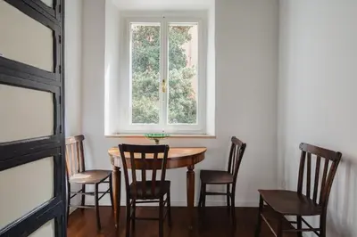 a table and chairs in a room with a window at Dadi Inn Monti in Rome