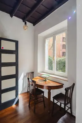 a dining room with a table and chairs and a window at Dadi Inn Monti in Rome