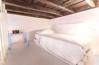 a white bedroom with a bed and a table at Dadi Inn Monti in Rome