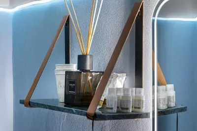 a shelf on a wall with a bottle of perfume at LPR Pantheon - Stylish Apartment at the Pantheon in Rome
