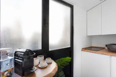 a kitchen with a wooden table with cups on it at LPR Pantheon - Stylish Apartment at the Pantheon in Rome
