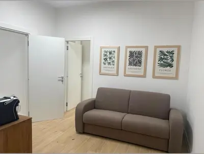 a living room with a couch and three pictures on the wall at Cola di Rienzo 243 Relais-A in Rome