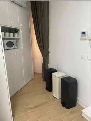 a hallway with two black suitcases in a kitchen at Cola di Rienzo 243 Relais-A in Rome
