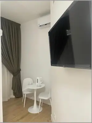 a small white table and chairs in a room at Cola di Rienzo 243 Relais-A in Rome