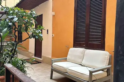 a couch sitting on a patio next to a building at Cola di Rienzo 243 Relais-A in Rome
