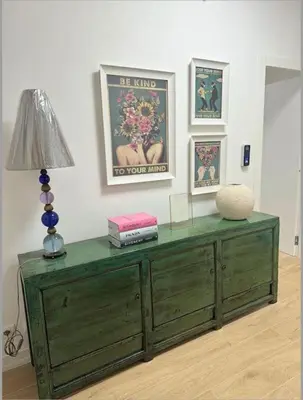 a green dresser in a room with a lamp and pictures at Cola di Rienzo 243 Relais-A in Rome