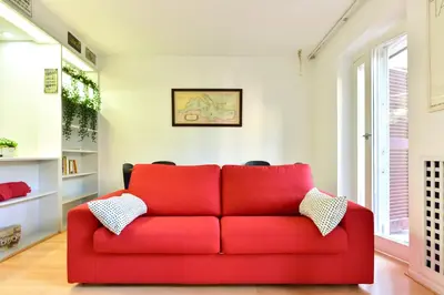 a red couch in a living room with a window at Appartamento Piazza Navona in Rome