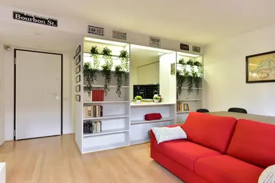 a living room with a red couch and a mirror at Appartamento Piazza Navona in Rome