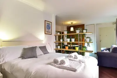 a bedroom with a white bed with towels on it at Appartamento Piazza Navona in Rome