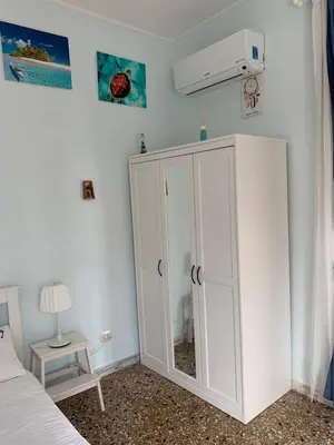 a bedroom with a white cabinet and a bed at Home Carpiceci in Rome