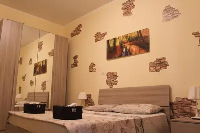 a bedroom with two beds and a mirror at Home Carpiceci in Rome