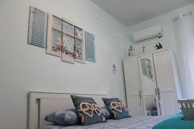 a bedroom with a bed with blue pillows on it at Home Carpiceci in Rome