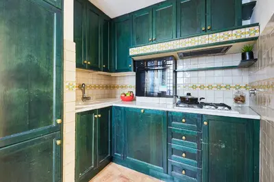 a green kitchen with green cabinets and a sink at iFlat Magnificent flat near the Colosseum in Rome