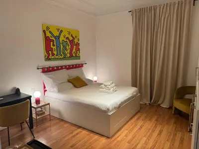 a bedroom with a bed with a painting on the wall at Be Your Home - Mazzini 144 in Rome