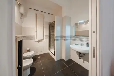 a bathroom with two toilets and a sink at Be Your Home - Mazzini 144 in Rome