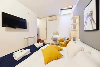 a bedroom with a large bed with a tv on the wall at iFlat Wonderful Home in Monti in Rome