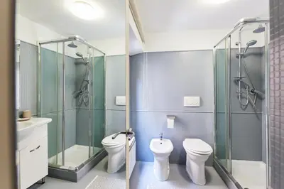 a bathroom with two toilets and a shower at iFlat Wonderful Home in Monti in Rome