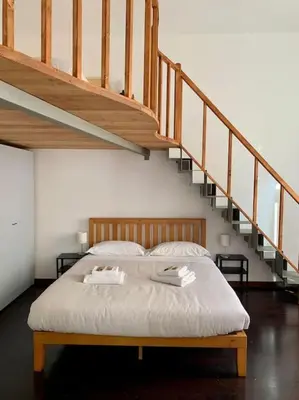 a bed in a room with a staircase at Super appartamento nel cuore del Pigneto in Rome