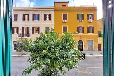 an orange tree in front of a yellow building at Super appartamento nel cuore del Pigneto in Rome