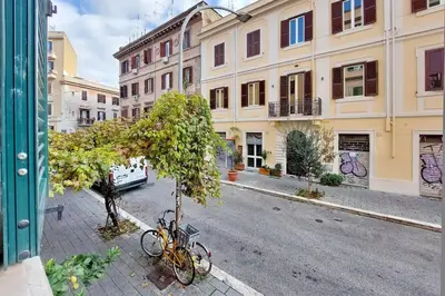 a bike parked next to a tree on a street at Super appartamento nel cuore del Pigneto in Rome