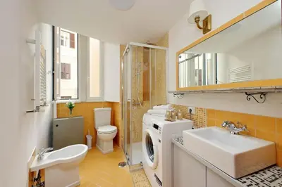 a bathroom with a sink and a washing machine at Super appartamento nel cuore del Pigneto in Rome