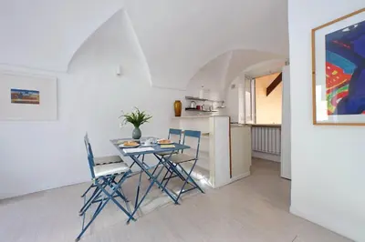 a kitchen and dining room with a table and chairs at Cimarra Apartment in Rome