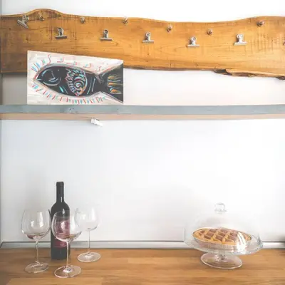 a shelf with two glasses and a bottle of wine at Casa Esquilina in Rome