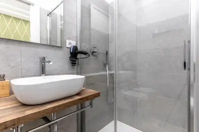 a bathroom with a sink and a shower at B&B Toto al Vaticano in Rome