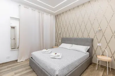 a bedroom with a bed with two towels on it at B&B Toto al Vaticano in Rome
